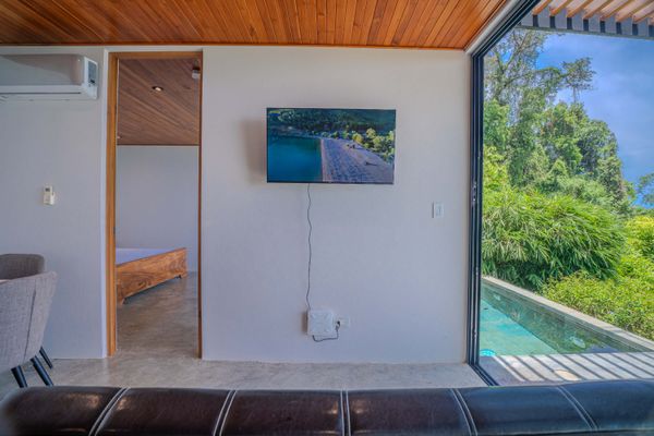 Wall-mounted TV in the living area for relaxing evenings indoors.