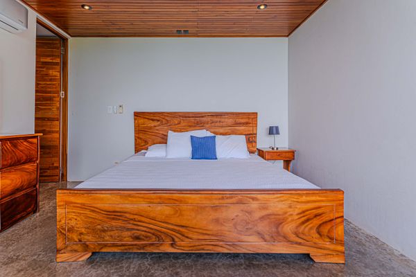 Relax in a calm bedroom with warm wood details and a restful, minimalist design.