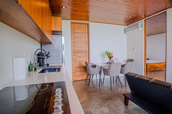 Cook and dine with ease in a thoughtfully equipped kitchen with warm wood details.