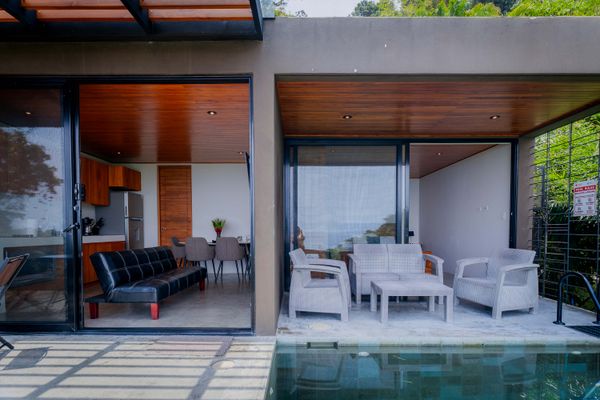 A covered outdoor lounge connects seamlessly with the villa’s indoor living space.