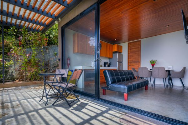 A seamless indoor-outdoor living space connecting the villa, terrace, and pool area.