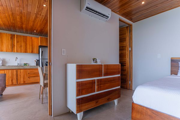 Comfortable bedroom area with storage space and warm wood accents.