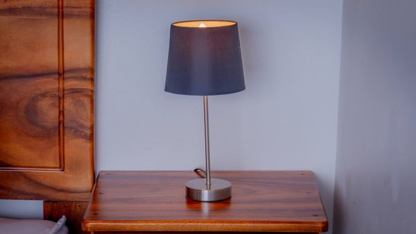 Soft bedside lighting and natural wood finishes create a calm, relaxing bedroom feel.