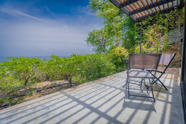Relax on the open terrace while taking in peaceful ocean and jungle views.