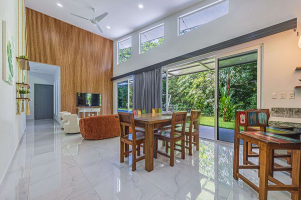 Spacious living area, designed with large windows that frame the pool perfectly.