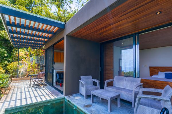 Indoor-outdoor living area with terrace seating and direct access to the villa.
