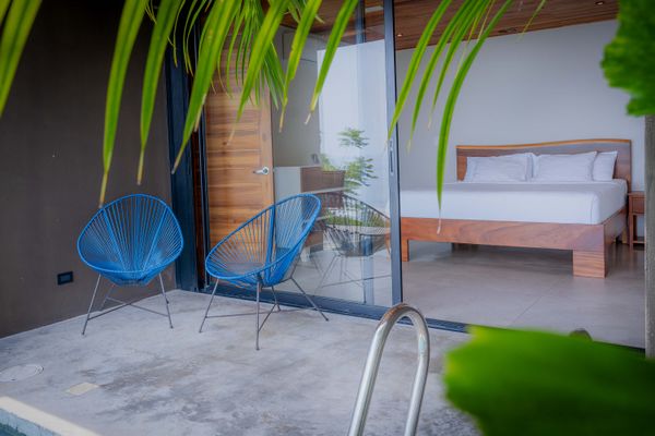 Private terrace with lounge chairs and direct access to the bedroom.