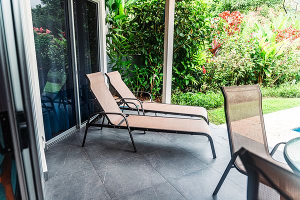 Elegant outdoor furniture perfect for lounging by the pool.