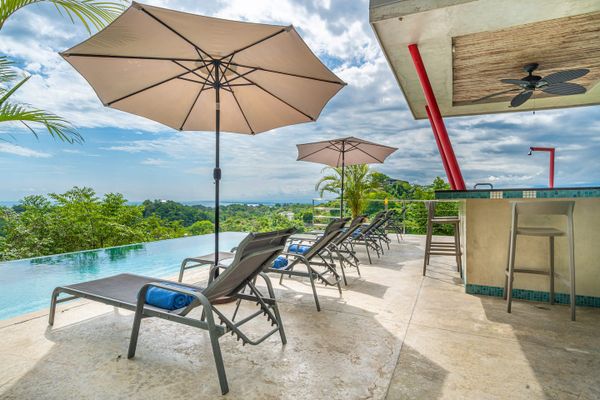 Wonderful pool deck, sun chairs and bar is great for enjoying the pool area.
