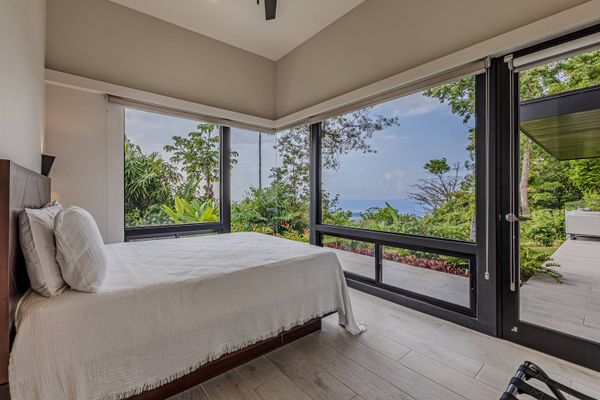 Bedroom #2 has ocean views, views of the swimming pool+waterfall and patio/swimming pool access from the bedroom.