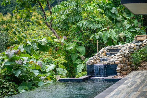 Private swimming pool with waterfall.