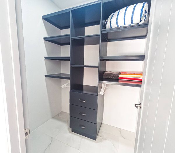 A spacious wardrobe in the master bedroom, offering ample storage and sleek design.