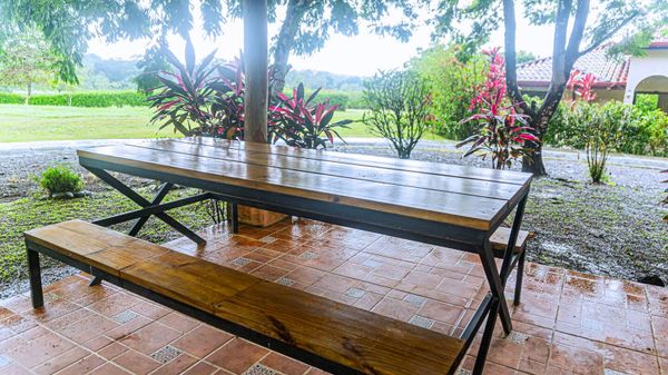 A spacious grill area with a large dining table, perfect for family gatherings.