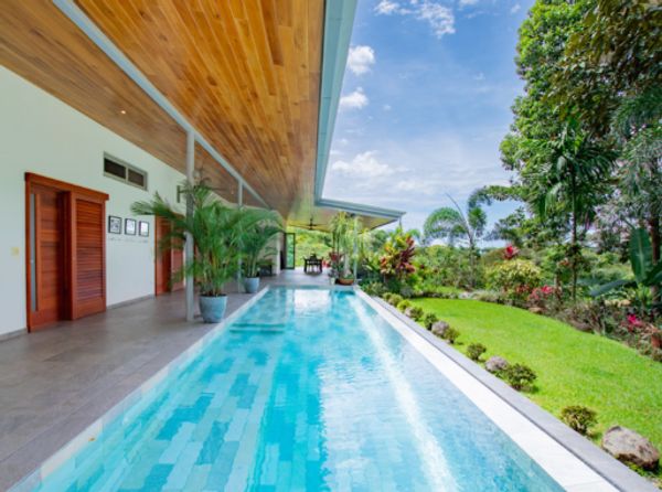 A wide, sparkling pool with plenty of space for swimming and lounging.