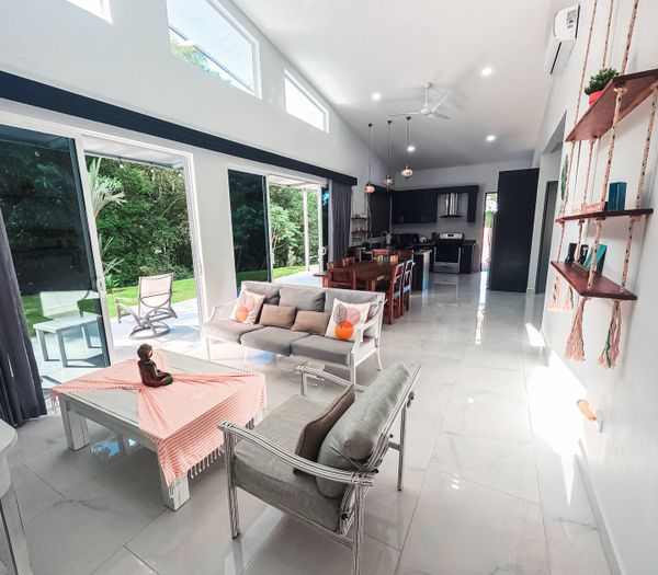 spacious living area, designed with large windows that frame the pool perfectly.