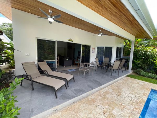 Crystal-clear swimming pool with lounge chairs for relaxation.