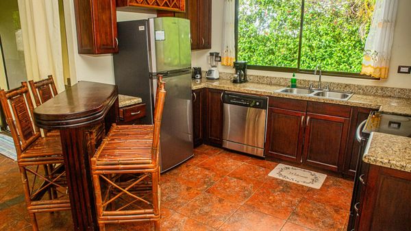 cozy kitchen features warm tones and functional design, creating a welcoming space to cook and gather