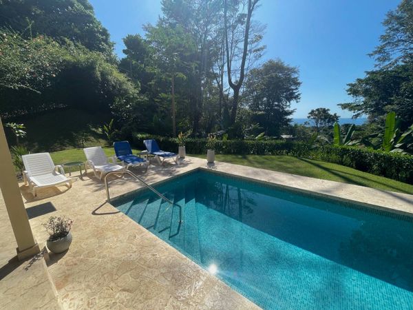 The beautiful sunlight shimmering on the pool, creating a sparkling, serene effect.