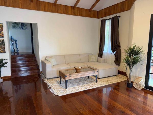 Large TV and living room in Main House on second floor with balcony.