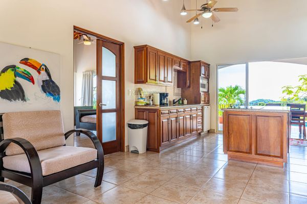 An expansive kitchen with a direct view of the sparkling pool.