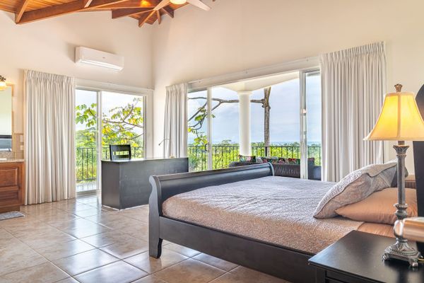 Owner's Suite with en-room bathroom, desk, access to patio.