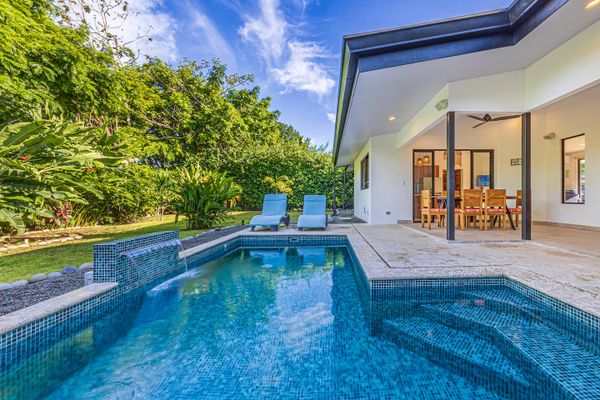 spacious pool area surrounded by lush landscaping.