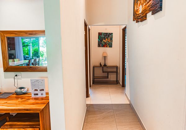 A well-lit hallway that seamlessly connects all three bedrooms