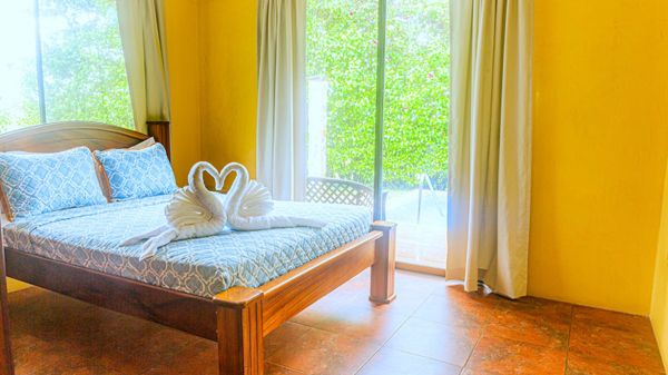 The master bedroom features a private bath, abundant daylight, and a scenic view of the pool.