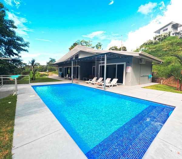 A beautiful house featuring a private pool, creating a serene oasis for relaxation.