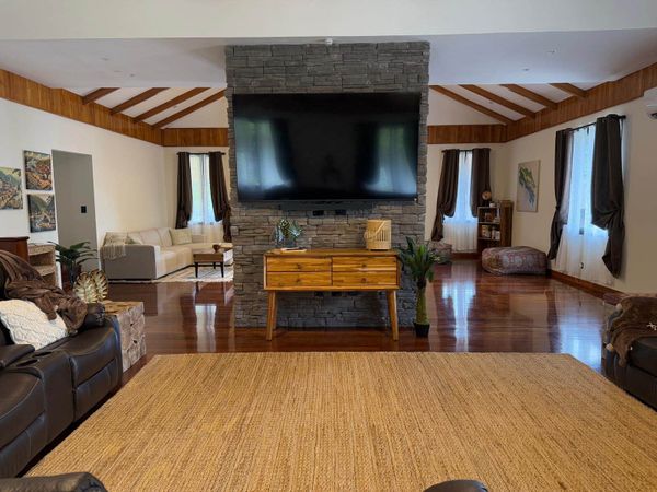 Large TV and living room in Main House on second floor with balcony.
