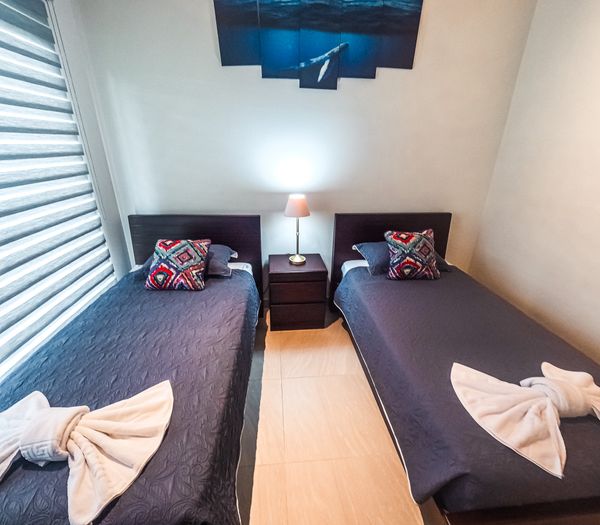 A functional third bedroom with twin beds, offering comfort and convenience.