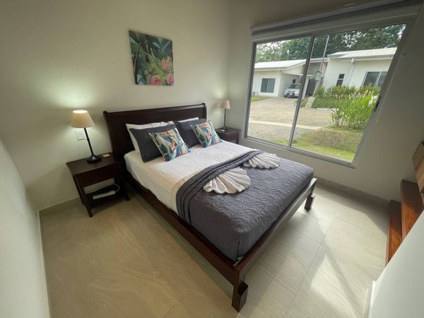 Beautiful bedroom #2 with a queen bed, AC and ceiling fan.