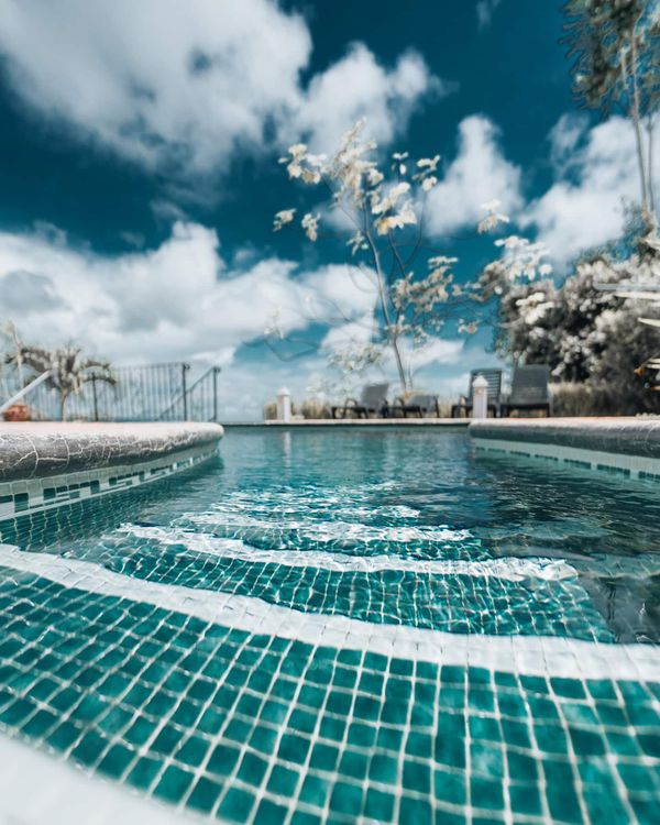 A luxurious pool with sparkling, crystal-clear water, perfect for enjoying the outdoors.