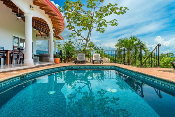 A spacious poolside lounge area, perfect for relaxing and enjoying the sun.