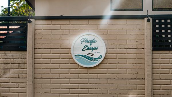 A decorative metal sign with the house’s name, subtly enhancing the entrance's charm.