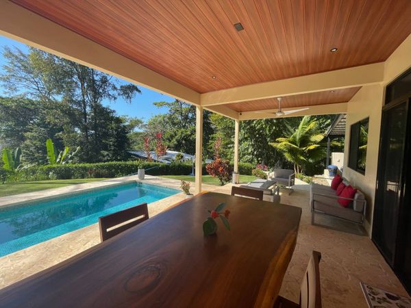 beautiful, oversized table outdoors, right next to the pool for seamless indoor-outdoor living