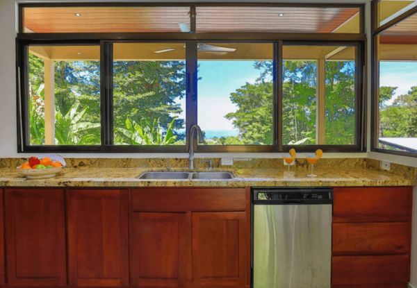 A bright, inviting kitchen with a picturesque view of the surrounding nature