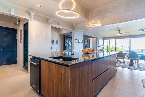 An elegant, open-concept kitchen, blending sleek surfaces with high-end finishes.