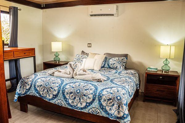 Master Bedroom with king-size bed, A/C and ceiling fan.
