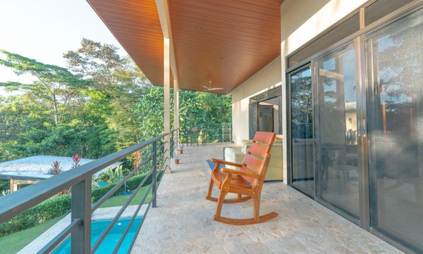 A stunning living room on the second-floor terrace, offering panoramic views and cozy seating.