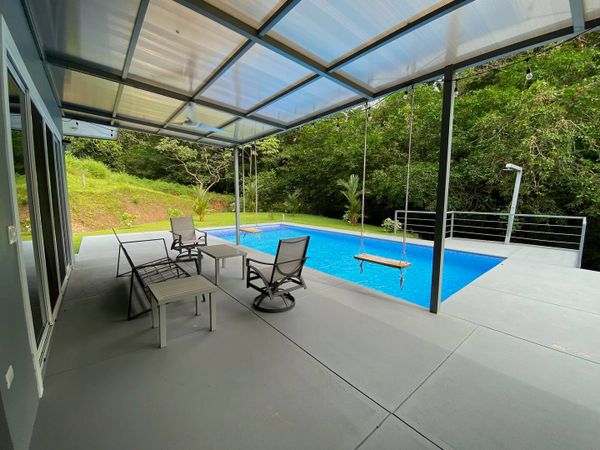 An elegant pool area with a sleek design, offering both luxury and comfort for outdoor living.