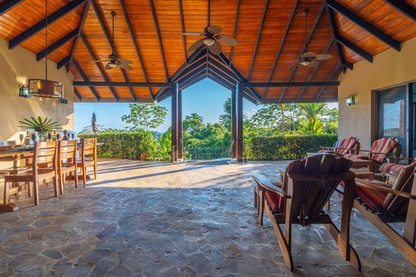 Extensive covered patio with pool access and ocean views