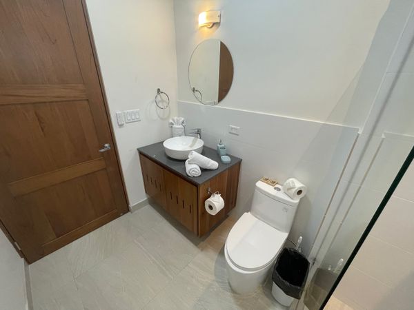 Gorgeous full bathroom at the hall with ceiling fan.