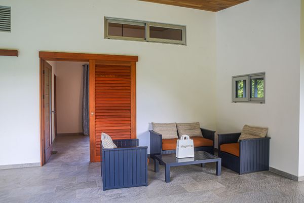 Outdoor covered sitting space next to the swimming pool