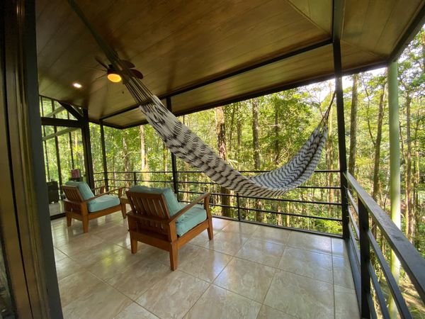 terrace offers panoramic views of lush greenery.