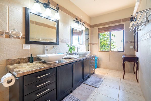 Master bedroom full bathroom with double sinks, indoor and outdoor shower