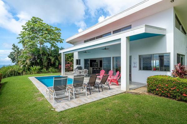 stunning poolside, with clear water and elegant lounging spaces for relaxation.
