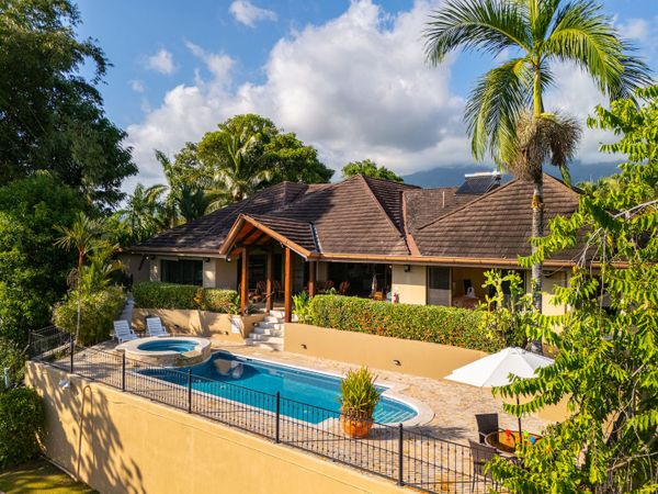 A stunning rear view of the house, with a tranquil pool and a serene outdoor space.