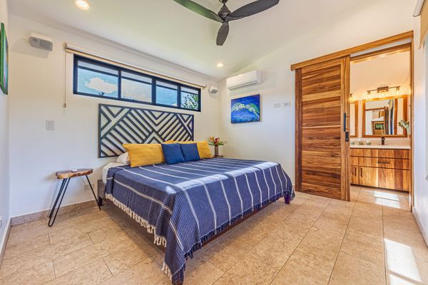 Main bedroom has king-size bed, A/C, ceiling fan and en-suite bathroom.