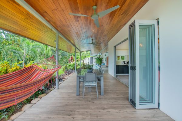 A large dining table with a beautiful view of the pool, perfect for outdoor meals.